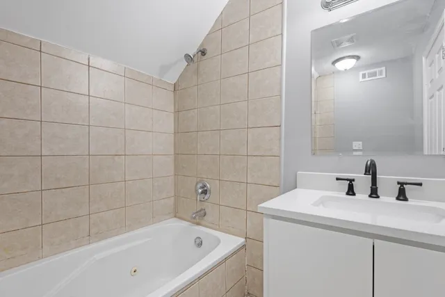 a bathroom with a bathtub and sink