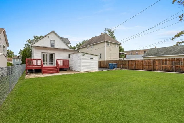 a view of backyard of house with green space