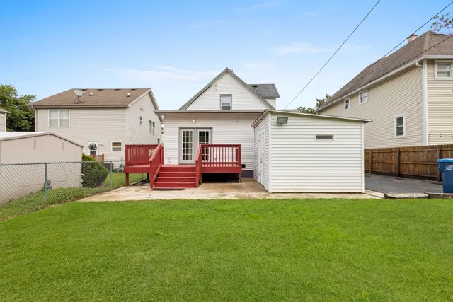 a view of a house with a yard and deck