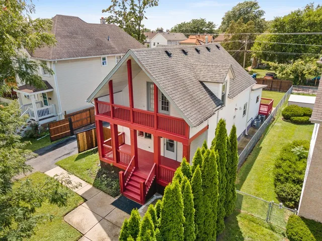an aerial view of a house with swimming pool and garden