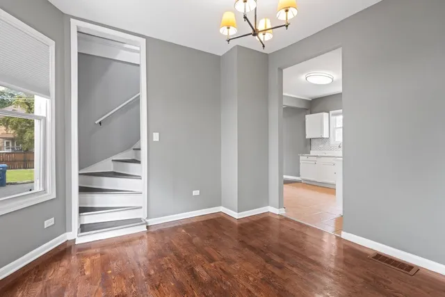 a view of a room with wooden floor and windows