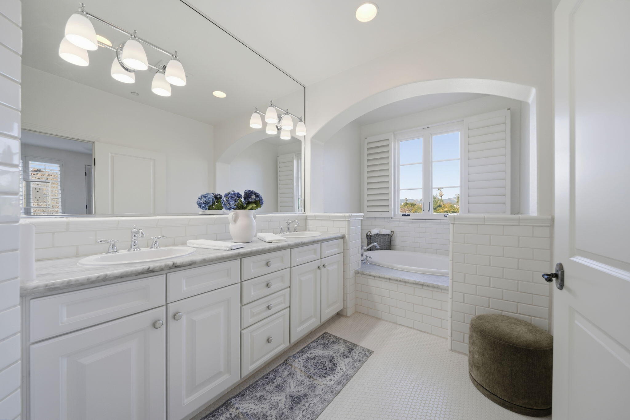 218 Santa Barbara Street, Unit D Santa Barbara, CA 93101 - Photo 12 of 25 a bathroom with a double vanity sink a toilet a mirror and shower