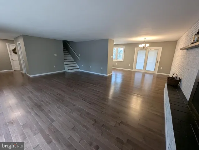 a kitchen with granite countertop a stove a sink and a microwave