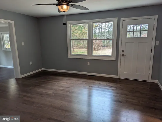 a utility room with washing machine and a view of bedroom