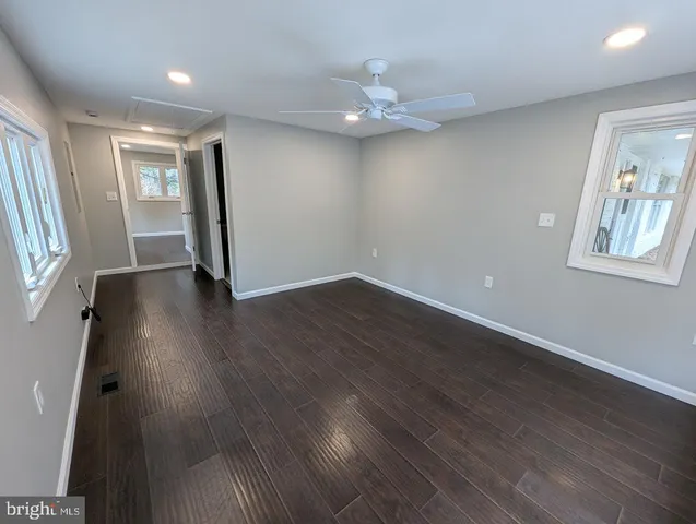 a white toilet sitting next to a shower