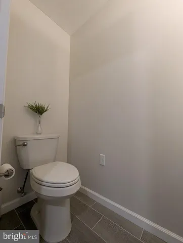 a view of an empty room and chandelier fan