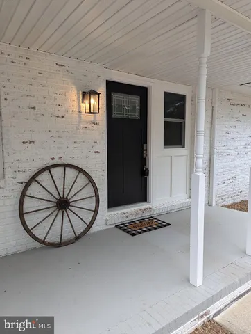 a view of a livingroom with furniture and entryway