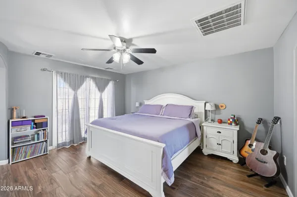 a bedroom with a bed and a chandelier