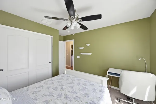 a bedroom with a bed and a chair