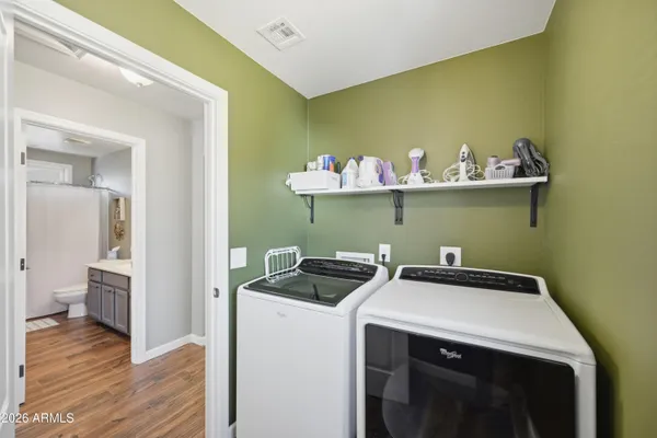 a kitchen with a sink a microwave and cabinets