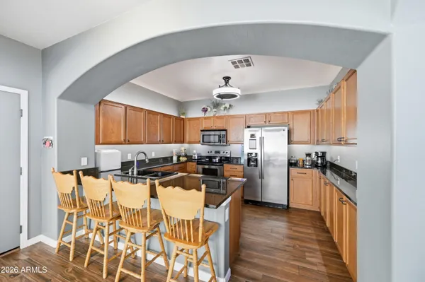 a kitchen with refrigerator and cabinets