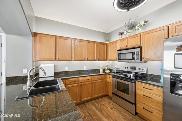 a kitchen with stainless steel appliances a sink stove and cabinets