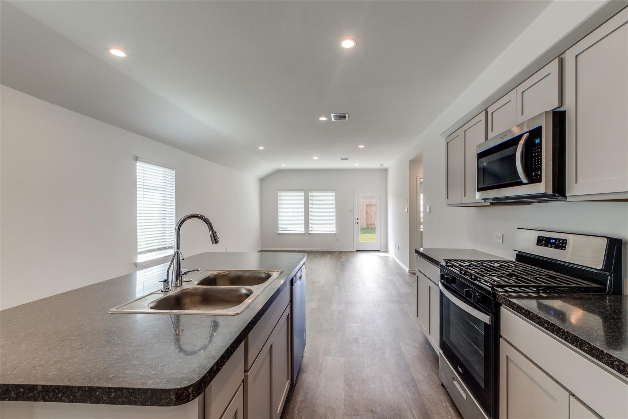 24323 Cayman Heights Lane Spring, TX 77373 - Photo 11 of 12 a kitchen with stainless steel appliances granite countertop a sink a stove and cabinets