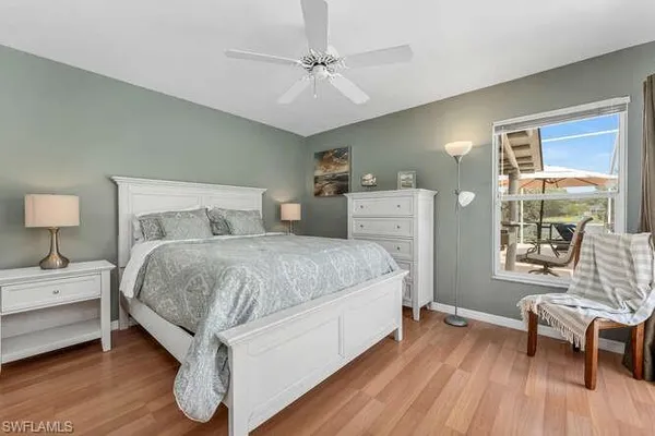 a spacious bedroom with a bed and wooden floor
