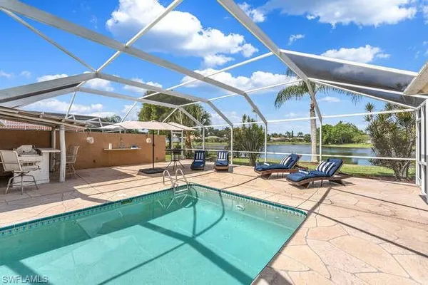 a view of a backyard with a patio and fire pit