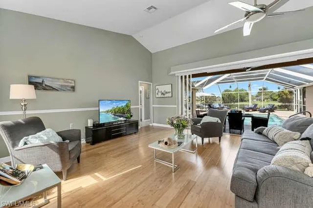 a living room with furniture large window and a flat screen tv