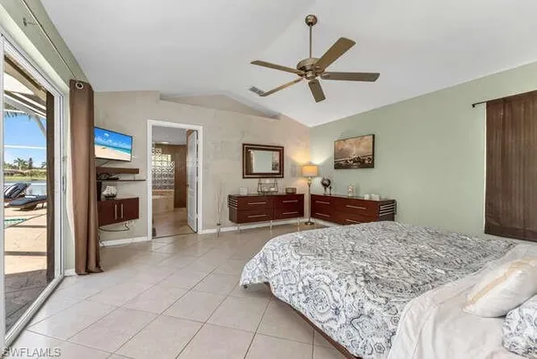 a bedroom with a large bed and a chandelier