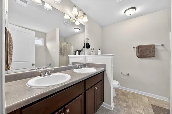 a bathroom with a granite countertop sink a large mirror and vanity