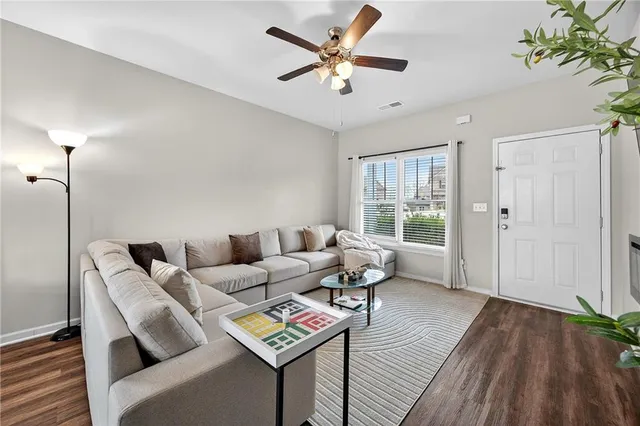 a living room with furniture and a wooden floor