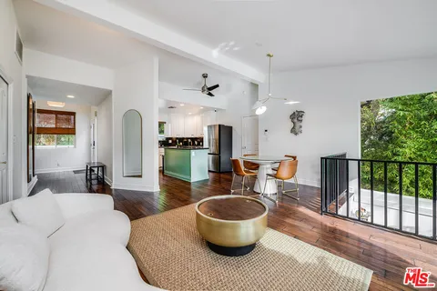 a kitchen with stainless steel appliances granite countertop a refrigerator a sink a stove a microwave and island