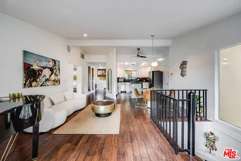a kitchen with a stove and a wooden floor