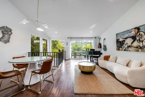 a bedroom with a bed and a flat tv screen on dresser