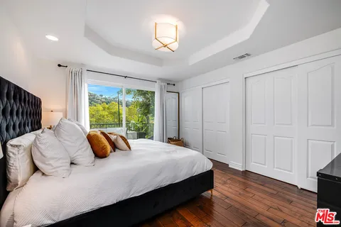 a living room with furniture and a kitchen view