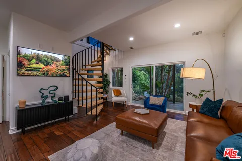 a living room with furniture and stairs