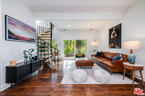 a outdoor sitting area with a couch and a potted plant
