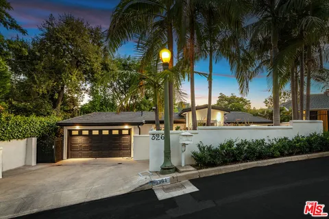 a view of a balcony with wooden floor and outdoor seating