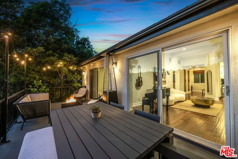 a balcony with furniture and a potted plant
