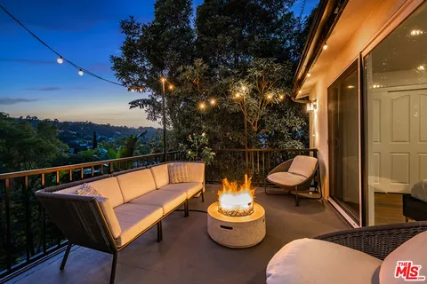 a view of a deck with table and chairs with wooden floor and fence