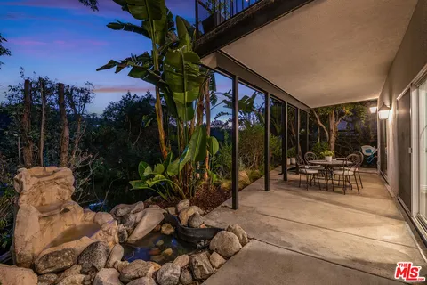 a spacious bathroom with a granite countertop sink a mirror and shower