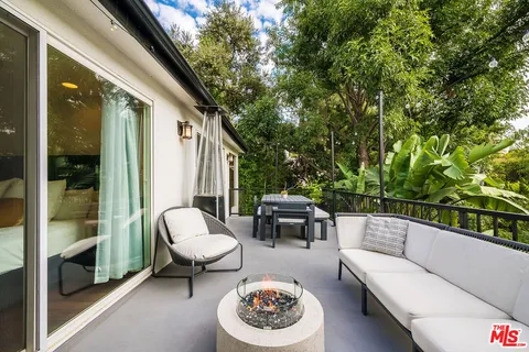 a bathroom with a granite countertop sink a mirror and a shower