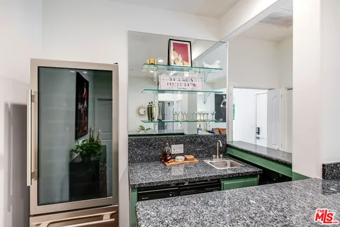 front view of house with a yard and potted plants