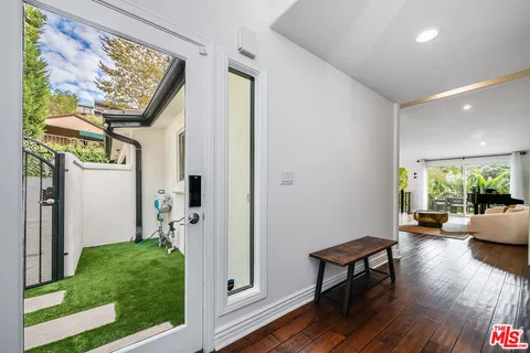 a living room with furniture a window and kitchen view
