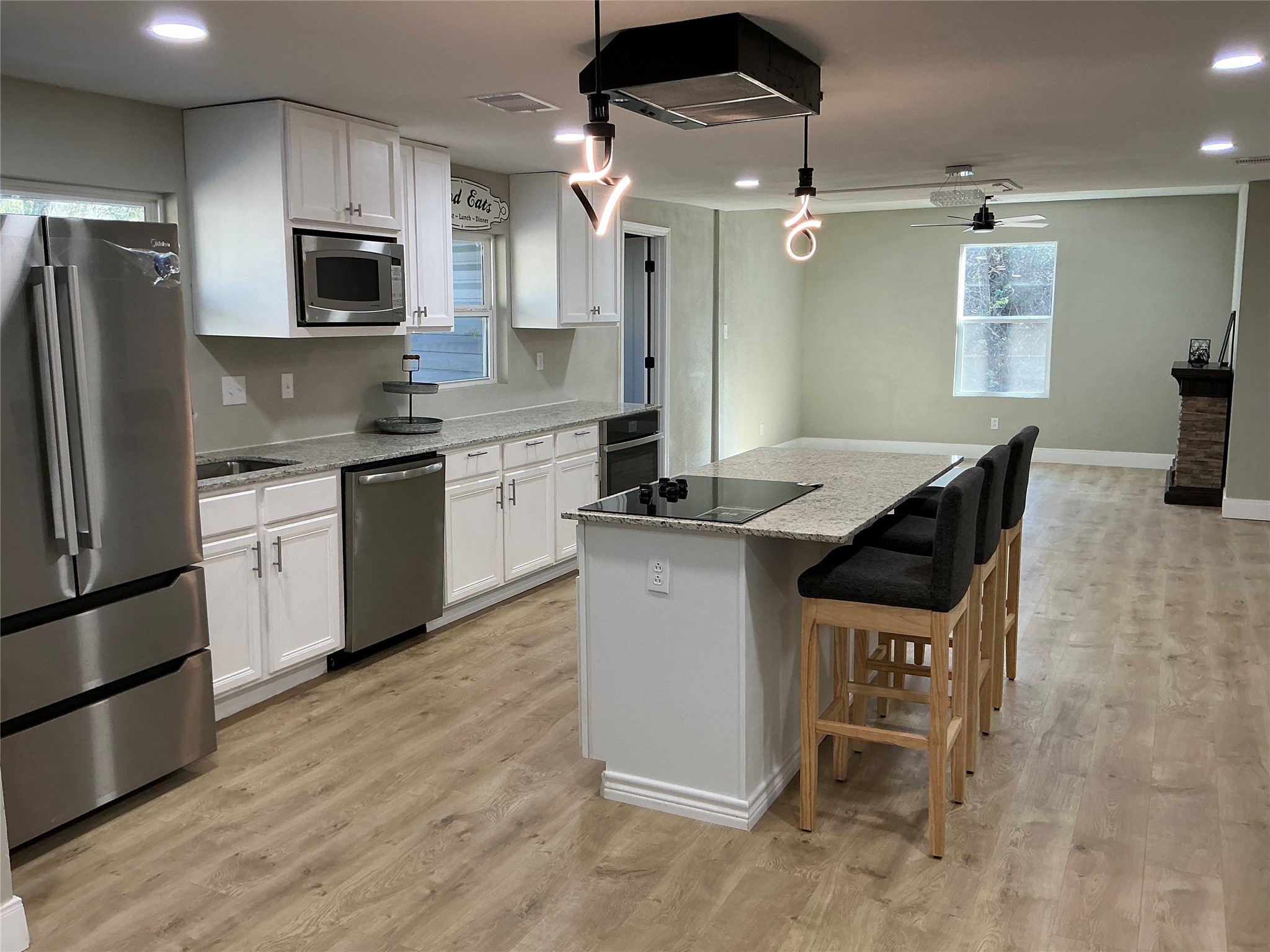 10928 L And M Road Montgomery, TX 77316 - Photo 11 of 31 a kitchen with granite countertop a stove a sink and a refrigerator