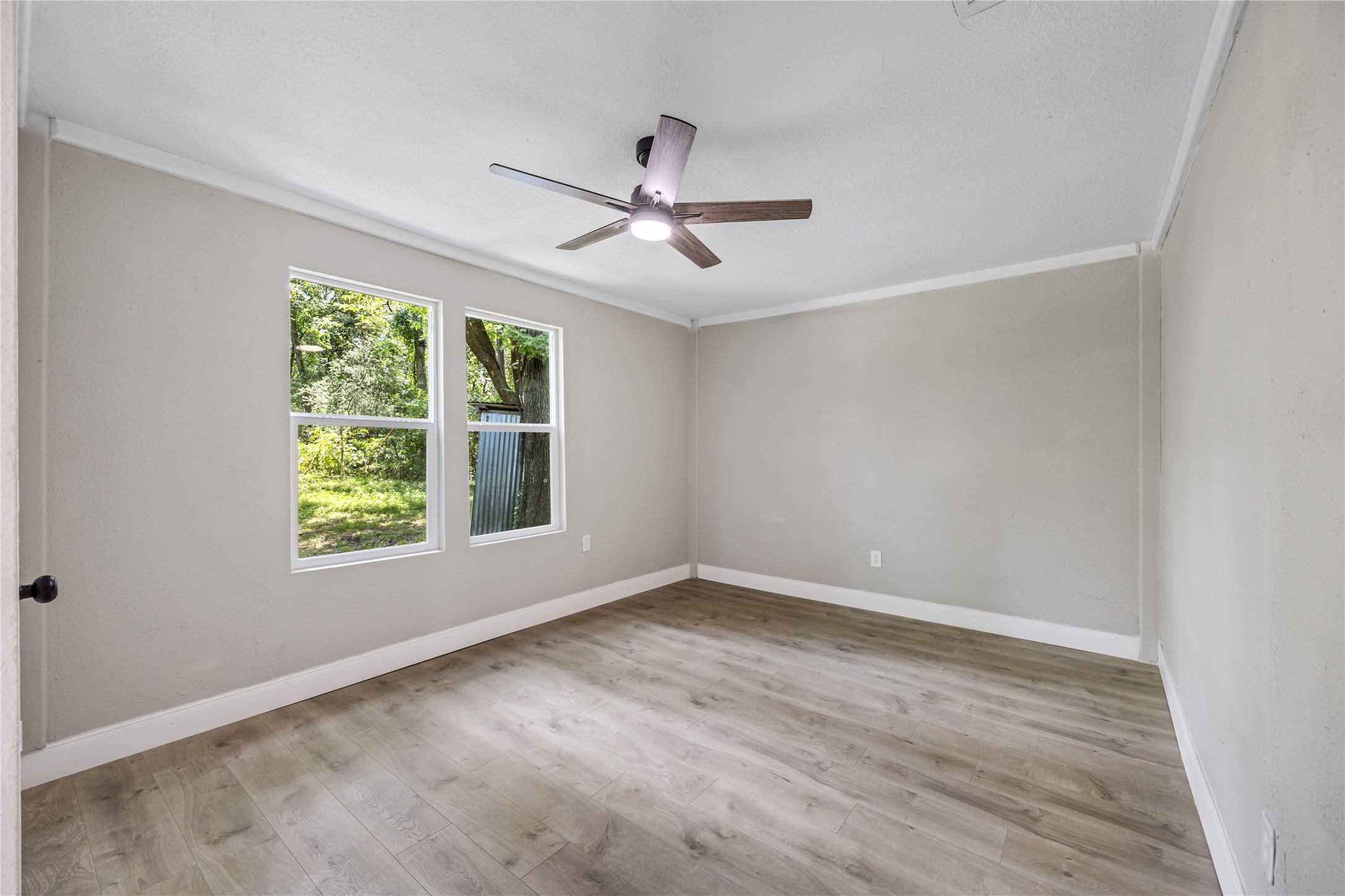 10928 L And M Road Montgomery, TX 77316 - Photo 20 of 31 a view of empty room with wooden floor and fan
