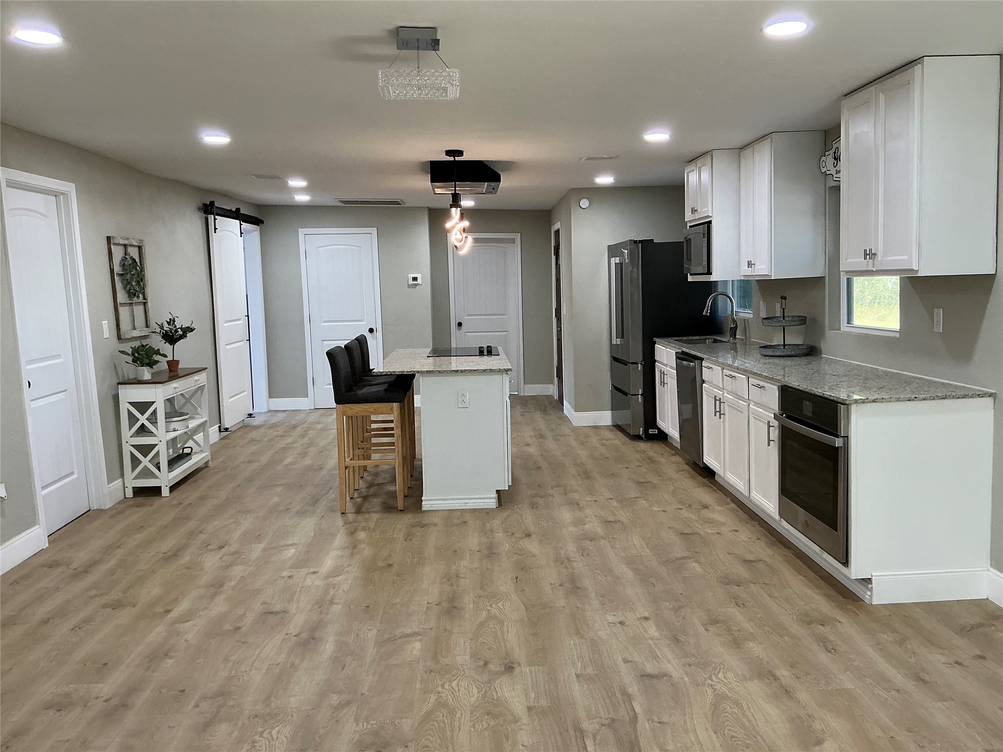 10928 L And M Road Montgomery, TX 77316 - Photo 9 of 31 a large kitchen with stainless steel appliances lots of counter space and windows