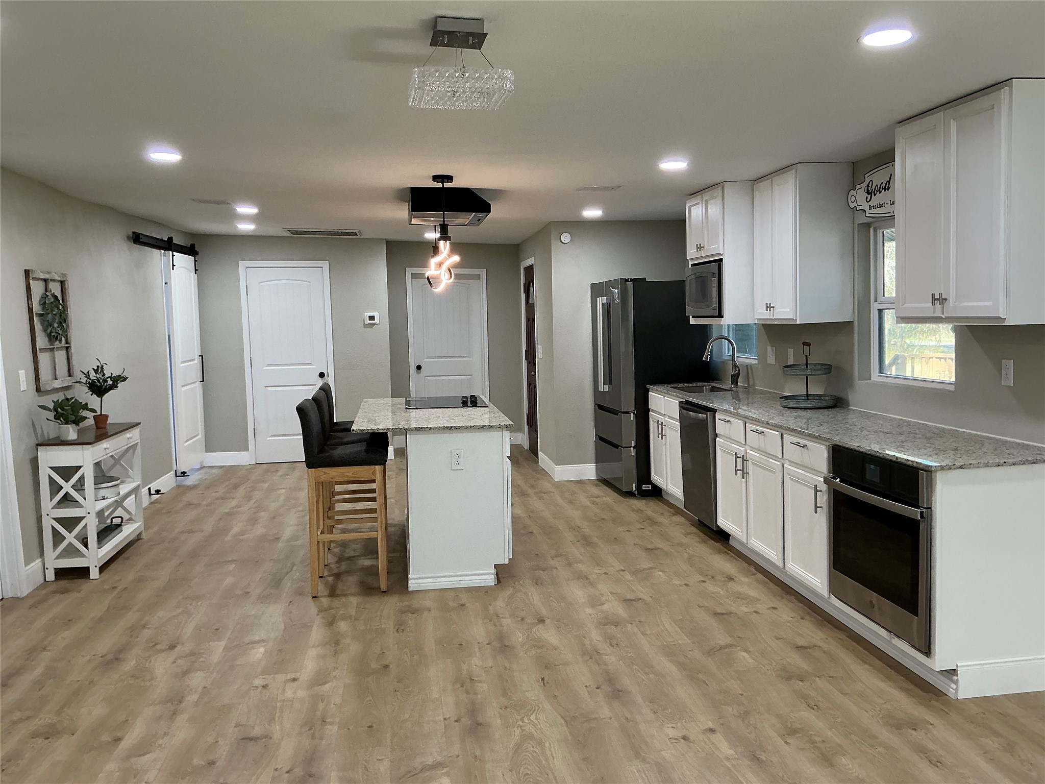 10928 L And M Road Montgomery, TX 77316 - Photo 10 of 31 a large kitchen with kitchen island a sink stainless steel appliances and cabinets