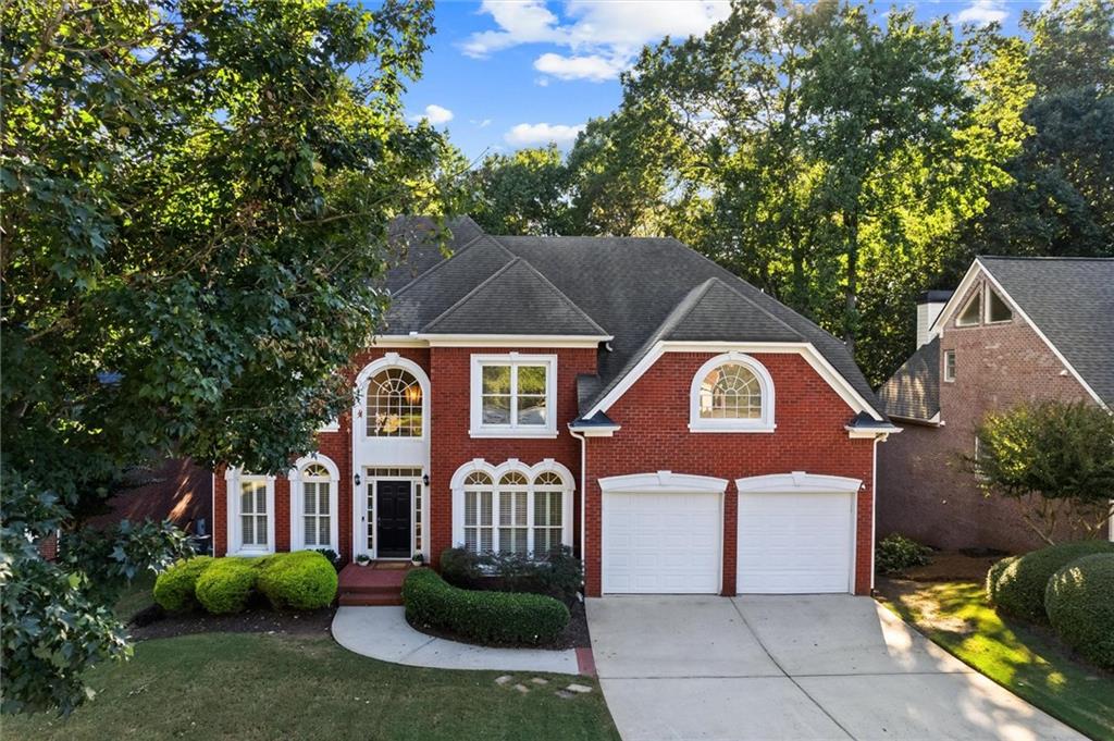 3184 Isleworth Trace Duluth, GA 30097 - Photo 1 of 75 a front view of a house with garden