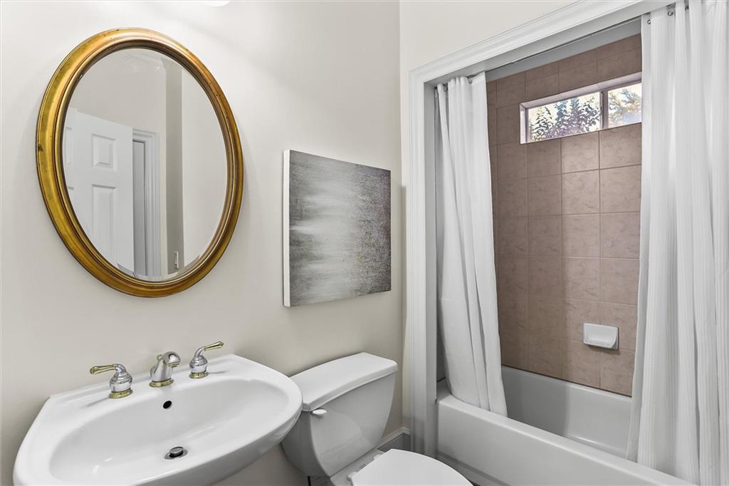3184 Isleworth Trace Duluth, GA 30097 - Photo 20 of 75 a bathroom with a sink a mirror a toilet and a shower