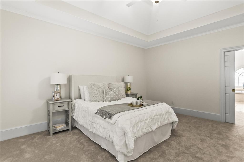 3184 Isleworth Trace Duluth, GA 30097 - Photo 33 of 75 a bedroom with a bed and a chandelier