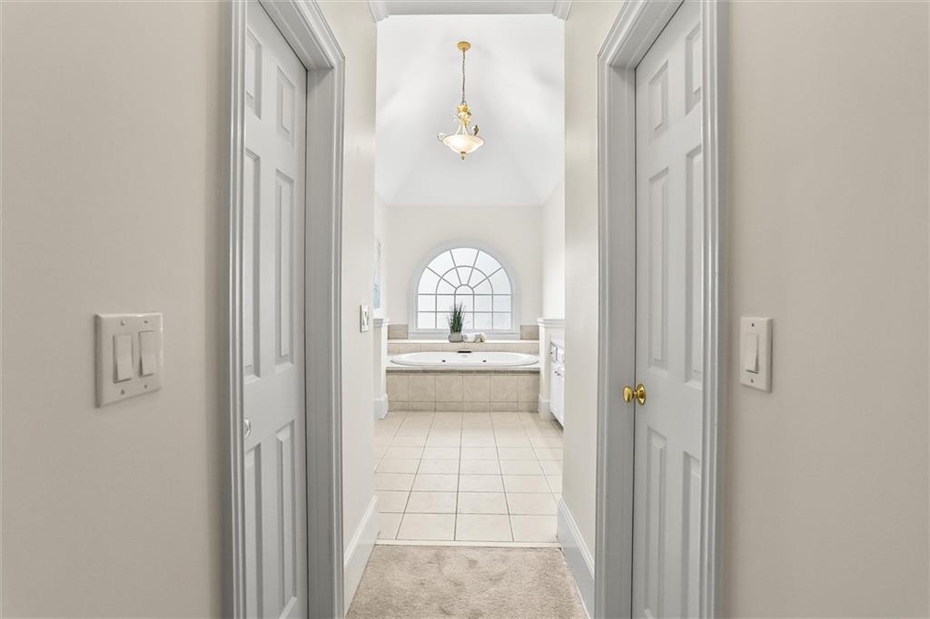 3184 Isleworth Trace Duluth, GA 30097 - Photo 36 of 75 a en suite bathroom with a sink mirror and shower