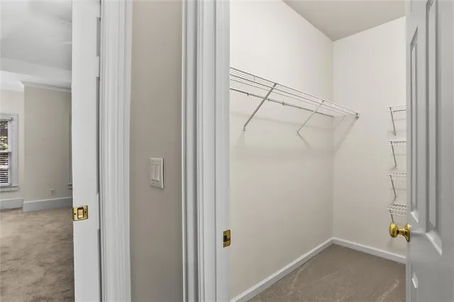 a view of a kitchen with wooden cabinet and a ceiling fan