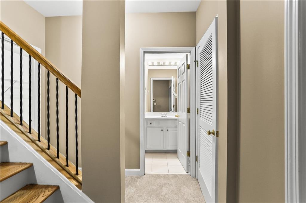 3184 Isleworth Trace Duluth, GA 30097 - Photo 55 of 75 a view of a hallway with wooden floor and staircase