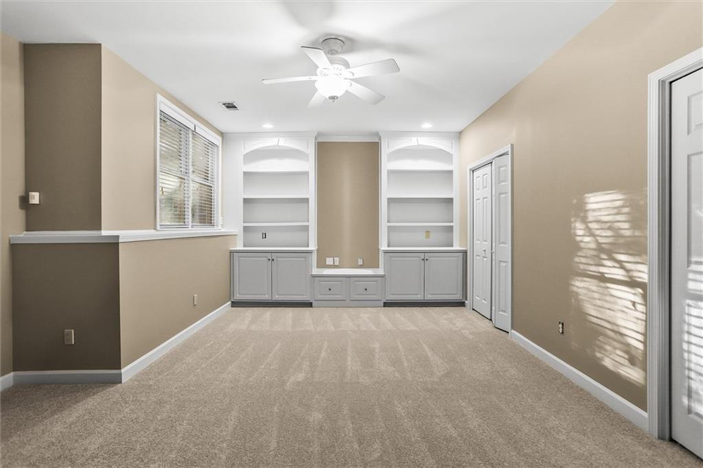 3184 Isleworth Trace Duluth, GA 30097 - Photo 64 of 75 a view of a kitchen with wooden cabinet and a ceiling fan