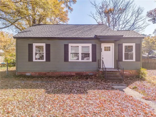 a view of a brick house with a yard