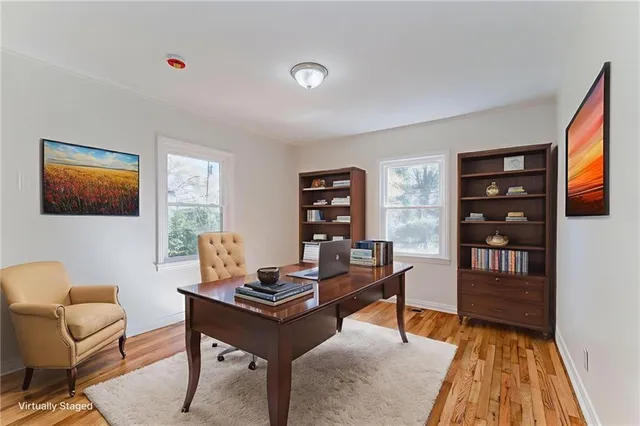 a living room with furniture a piano and a bookshelf