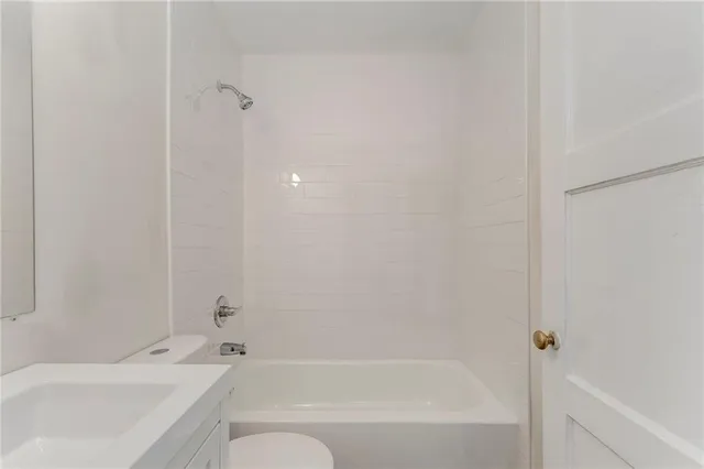a bathroom with a bathtub and shower